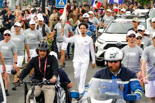 Photo de la flamme olympique transportée dans les rues de Bordeaux.