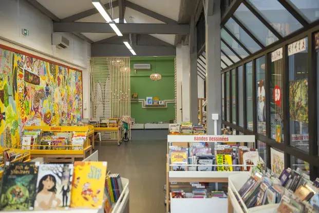 Photo d'étagères de bande-dessinée dans la bibliothèque Capcuins / Saint-Michel