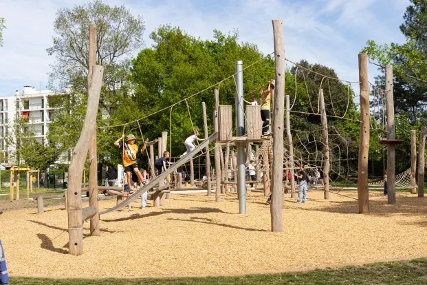 photo d'enfants jouant sur une aire de jeux en bois